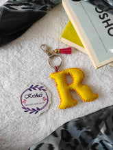 Load image into Gallery viewer, Key ring bag charm. Cute bag charm with stuffed alphabet. Hand bag charms. Felt bag charm. Unusual bag charm. Pink bag charm. Bag charm with lobster claw clip. Luxury bag charm. Tessel bag charm.
