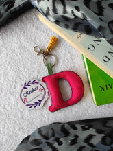 Load image into Gallery viewer, Key ring bag charm. Cute bag charm with stuffed alphabet. Hand bag charms. Felt bag charm. Unusual bag charm. Pink bag charm. Bag charm with lobster claw clip. Luxury bag charm. Tessel bag charm.