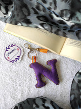 Load image into Gallery viewer, Key ring bag charm. Cute bag charm with stuffed alphabet. Hand bag charms. Felt bag charm. Unusual bag charm. Pink bag charm. Bag charm with lobster claw clip. Luxury bag charm. Tessel bag charm.