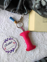 Load image into Gallery viewer, Key ring bag charm. Cute bag charm with stuffed alphabet. Hand bag charms. Felt bag charm. Unusual bag charm. Pink bag charm. Bag charm with lobster claw clip. Luxury bag charm. Tessel bag charm.