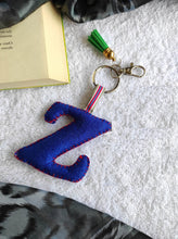 Load image into Gallery viewer, Key ring bag charm. Cute bag charm with stuffed alphabet. Hand bag charms. Felt bag charm. Unusual bag charm. Pink bag charm. Bag charm with lobster claw clip. Luxury bag charm. Tessel bag charm.