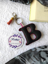 Load image into Gallery viewer, Key ring bag charm. Cute bag charm with stuffed alphabet. Hand bag charms. Felt bag charm. Unusual bag charm. Pink bag charm. Bag charm with lobster claw clip. Luxury bag charm. Tessel bag charm.