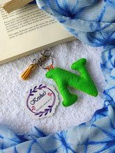 Load image into Gallery viewer, Key ring bag charm. Cute bag charm with stuffed alphabet. Hand bag charms. Felt bag charm. Unusual bag charm. Pink bag charm. Bag charm with lobster claw clip. Luxury bag charm. Tessel bag charm.