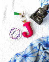 Load image into Gallery viewer, Key ring bag charm. Cute bag charm with stuffed alphabet. Hand bag charms. Felt bag charm. Unusual bag charm. Pink bag charm. Bag charm with lobster claw clip. Luxury bag charm. Tessel bag charm.