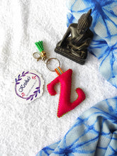 Load image into Gallery viewer, Key ring bag charm. Cute bag charm with stuffed alphabet. Hand bag charms. Felt bag charm. Unusual bag charm. Pink bag charm. Bag charm with lobster claw clip. Luxury bag charm. Tessel bag charm.