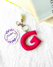 Load image into Gallery viewer, Key ring bag charm. Cute bag charm with stuffed alphabet. Hand bag charms. Felt bag charm. Unusual bag charm. Pink bag charm. Bag charm with lobster claw clip. Luxury bag charm. Tessel bag charm.