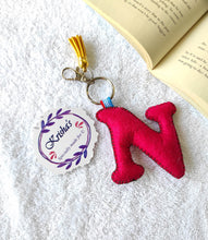 Load image into Gallery viewer, Key ring bag charm. Cute bag charm with stuffed alphabet. Hand bag charms. Felt bag charm. Unusual bag charm. Pink bag charm. Bag charm with lobster claw clip. Luxury bag charm. Tessel bag charm.
