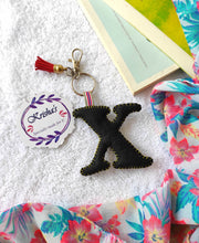 Load image into Gallery viewer, Key ring bag charm. Cute bag charm with stuffed alphabet. Hand bag charms. Felt bag charm. Unusual bag charm. Pink bag charm. Bag charm with lobster claw clip. Luxury bag charm. Tessel bag charm.