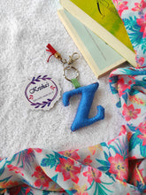 Load image into Gallery viewer, Key ring bag charm. Cute bag charm with stuffed alphabet. Hand bag charms. Felt bag charm. Unusual bag charm. Pink bag charm. Bag charm with lobster claw clip. Luxury bag charm. Tessel bag charm.