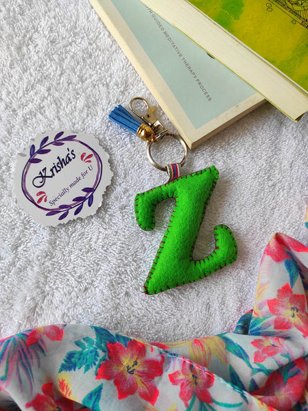 Key ring bag charm. Cute bag charm with stuffed alphabet. Hand bag charms. Felt bag charm. Unusual bag charm. Pink bag charm. Bag charm with lobster claw clip. Luxury bag charm. Tessel bag charm.